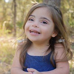 Little Qinn smiling outside